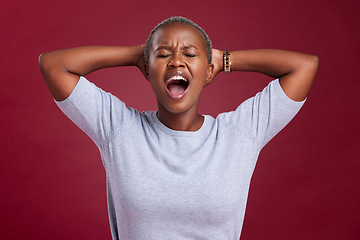 Image showing Screaming black woman, angry in studio with hands behind head and sad stress by wall for mental health. Woman frustrated, shouting depression anxiety in grief and moody face anger with red background