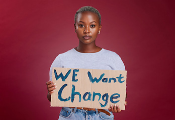Image showing Black woman, protest and billboard message for change, text or voice against mockup studio background. Portrait of African American female activist with banner, poster or sign for empowerment or vote