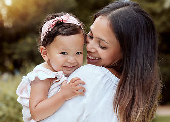 Image showing Happy mother with girl baby hug in a park with summer love, smile and care or growth development wellness. Happy latino mom with kid in portrait together nature outdoor for mothers day with happiness
