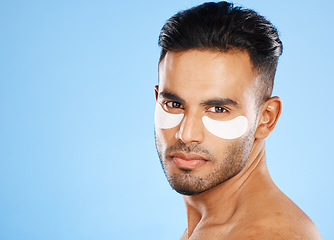 Image showing Skincare, eyes patch and man portrait of beauty product, body cosmetics and wellness, facial treatment and aesthetic health on studio blue background. Arab guy face portrait, hydration and self care