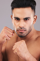 Image showing Fitness, fist and athlete man ready to fight, box and exercise in studio for health, wellness and training. Sports, workout and strong MMA male fighter with hands in defense for martial arts fighting