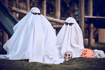 Image showing Halloween, glasses and people in ghost costume for trick or treat, global dress up day or fun on playground grass field. Fear fantasy, horror and relax friends role play scary phantom monster at park