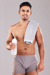 Image showing Man, body and water bottle for fitness on studio background in workout, training or exercise for health, wellness or strong muscles. Portrait, smile and happy sports athlete with drink or sauna towel