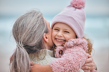 Image showing Happy family, beach and mother and child hug, bond or enjoy fun quality time together while relax on ocean sand. Love, peace and outdoor winter freedom for woman, mom or mama with kid girl in nature