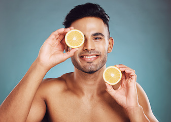 Image showing Beauty, man and face, fruit with smile in portrait, grooming and natural cosmetics, skincare advertising with studio background. Indian, citrus and skin with wellness and hygiene, clean and fresh