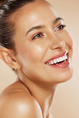 Image showing Face, beauty and skincare with a model woman in studio on a beige background with a happy smile or idea for wellness. Luxury, cosmetics and natural with a young female posing to promote a product