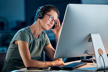 Image showing Call center, woman and stress at night with computer, stressed and overworked in office, tired and headache. Female consultant frustrated, experience burnout and headset, anxiety and mental health.