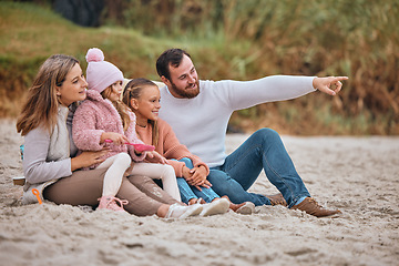 Image showing Family, travel and beach with children and parents on sand while pointing and learning about nature while on vacation, holiday or adventure. Man, woman and girl kids together for bonding outdoor