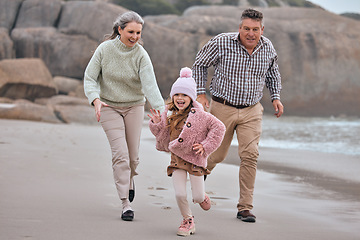 Image showing Beach, running and family grandparents with child holding hands for outdoor wellness, energy and development holiday. Happy, excited girl or kid with her grandmother and father run together by sea