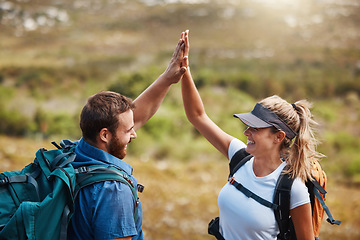 Image showing Couple, high five and hiking with motivation, goal and celebration for fitness target in nature with backpack. Man, woman and happy for partnership, excited or support while trekking together outdoor