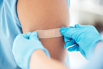 Image showing Bandaid, vaccine and arm of patient at the doctor for healthcare, medical attention and consultation with covid. Hands of a hospital nurse with a plaster for an injury, virus or safety while sick