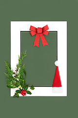 Image showing Christmas Eve Background Frame with Santa Hat Flora and Red Bow 