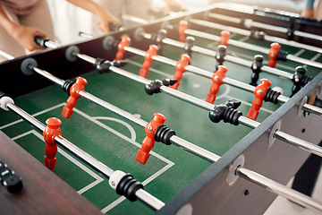 Image showing Foosball, game and fun with people playing a game inside of a clubhouse or at a party together. Soccer, table and competition with friends bonding over a match of football together for recreation