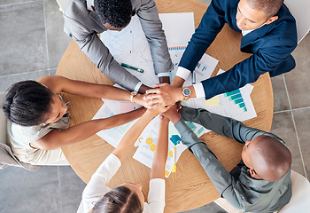 Image showing Hands, teamwork and motivation with a business team sitting at a table in a boardroom from above. Collaboration, meeting and unity with an employee group working on finance or accounting documents