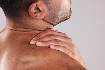 Image showing Man hand holding neck pain, hurt and body injured problem in studio. Male model hands from behind suffering with sore body injury, discomfort and strain or muscle sprain from fractured joints