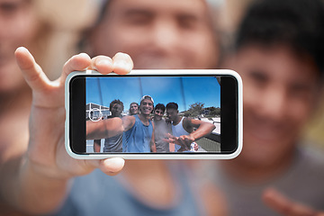 Image showing Phone, friends and selfie with a man group on a screen, posing for a photograph outdoor together. Portrait, mobile and display with a young male best friend taking a picture with his mates outside