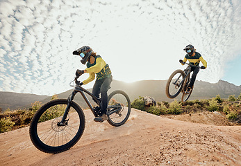 Image showing Cycling, mountain bike jump and man travel on dirt path for extreme sports adventure, journey or training for marathon race. Nature mountains, sky sun flare and freedom for fitness training cyclist