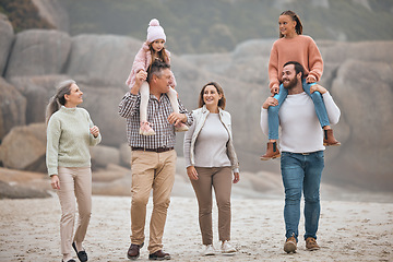 Image showing Family, children and beach with grandparents, parents and grandkids walking on the sand at the coast together. Summer, travel and love with a man, woman and kids bonding on a coastal walk outdoor