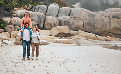 Image showing Family, walking and beach, travel and outdoor, mother and father with child spending quality time by the ocean. Love, together and man with woman and girl, parents bonding with kid out in nature.