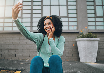 Image showing Phone, happy and woman taking a selfie on a street sidewalk outdoors to post online for social media. Smile, student and young girl enjoys taking pictures alone and posting them on a social network