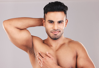 Image showing Beauty, portrait and skincare man happy with body care, grooming and hygiene for cosmetic advertising. Satisfaction of male model with muscles flexing healthy skin with mockup in gray studio.