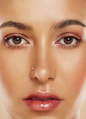 Image showing Makeup, portrait and woman with face cosmetics for luxury, wellness and beauty of eyes against a studio background. Glow, young and facial model closeup with cosmetic lashes and lipgloss for skin