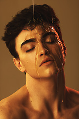 Image showing Honey, dripping and man face for beauty and skincare with food and liquid. Beautiful model person from Spain head with a relaxing facial expression with a creative, cosmetic art and artistic drip