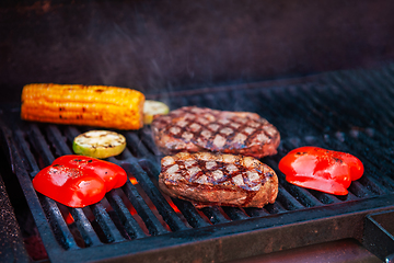 Image showing Pork meat steaks on the grill