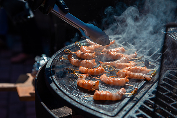 Image showing A professional cook prepares shrimps