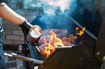 Image showing Pork meat steaks on the grill