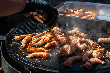 Image showing A professional cook prepares shrimps