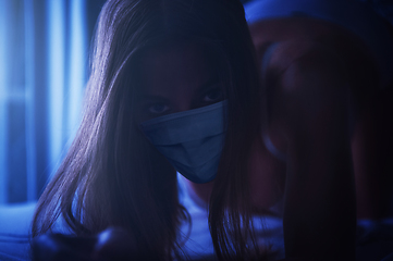 Image showing Woman in the bedroom with a medical disposable mask.