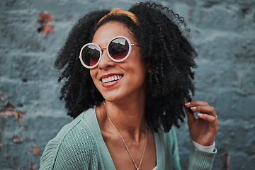 Image showing Black woman, fashion and smile with stylish glasses for summer travel against an urban wall background. Happy African American female smiling in satisfaction for fun funky style in the outdoors