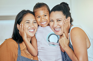 Image showing Mother, grandmother and child in apron, hug and cooking together in kitchen, smile in portrait, family and spending quality time. Filipino women hugging girl, happy and generations bonding at home.