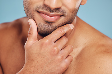 Image showing Hands, face and beauty with a man model posing in studio on a blue background for skincare or grooming. Cleaning, bathroom and wellness with a young male indoors to promote a natural cosmetic product