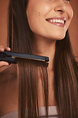 Image showing Woman flat iron, closeup hair care and cosmetic beauty with smile against brown studio background. Hair health happiness, happy cosmetic girl and hairstyle for wellness with heat, fashion or styling