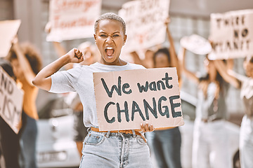 Image showing Woman, angry protest and banner in city street for freedom, peace and social diversity. Young black girl, people walk in protesting rally together and community collaboration for feminist empowerment