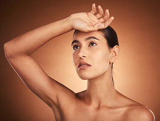 Image showing Beauty, skincare, and health of a woman with hand on head for wellness, self care and and self love of body and mind. Girl model with glow in studio from makeup, cosmetics and dermatology mockup