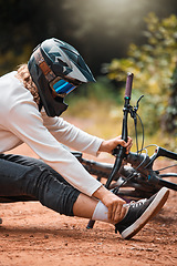 Image showing Ankle pain, cycling and man on the ground in a park with injured foot, pain and accident while riding bike for fitness. Foot pain, bicycle and dirt road accident, cyclist and foot injury in a forest