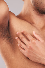 Image showing Armpit, clean and hand of man touching skin for health, wellness and beauty at a spa against a studio background. Skincare, luxury and model with cosmetic grooming, hygiene and care for body