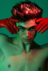 Image showing Neon, creative and face portrait of fashion model with red green lighting, attitude and serious light for artistic expression. Creativity, individuality and trendy man isolated on green background
