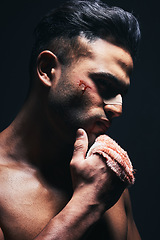 Image showing Injury, blood and man with a bandage from fighting or training for MMA or kickboxing in a dark studio. Violence, hurt and guy boxer from Mexico after sports competition isolated by black background.