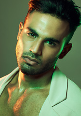 Image showing Fashion, green lights and portrait of sexy man from India in studio background creative shoot. Beauty, neon light and professional male model, Indian man and serious face in mens health and cosmetics
