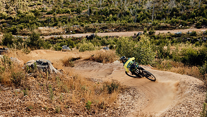 Image showing Mountain bike, man and cycling adventure on dirt hill, sand path and speed challenge, sports action or fast race in nature. Bicycle athlete, fitness and cardio freedom on outdoor competition training