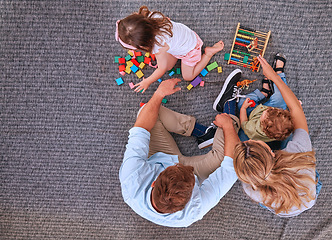 Image showing Family, children and learning with education toys, blocks and abacus for color game with mom and dad on floor. Man and women parents with kids for learning, development and playing on home carpet