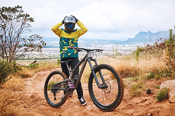 Image showing Mountain cyclist, bike and sports person on a outdoor nature road for a ride or sport race. Bicycle helmet, fitness and workout training of an adventure athlete on mountains and dirt path in Denver