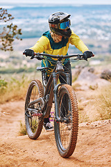 Image showing Bike, biker and outdoor sport with athlete and mountain bike, adventure and extreme sports. Fitness, exercise and cyclist ride through dirt track, workout in woods and training with safety helmet.