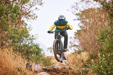 Image showing Bike, cyclist and sport, cycling in the woods, fitness and energy with extreme sports outdoor. Bicycle, exercise in nature and helmet for safety, active lifestyle and mountain biking in forest.