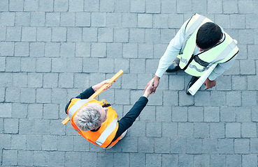 Image showing Builder, construction worker and architect handshake with aerial view of teamwork, labor collaboration and industrial project workers. Men shaking hands, thank you and engineering building contractor