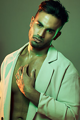 Image showing Beauty, green lights and portrait of sexy man from India touching bare chest in creative studio shoot. Fashion, neon light and professional male model, single Indian man with seductive and sexy style